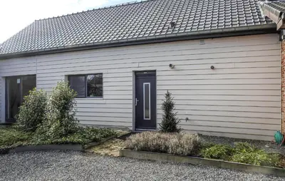 a white house with a black door on it at 2 Bedroom Beautiful Home In Herselt in Herselt