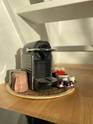 a coffee maker sitting on top of a table at The Conservatory, a cosy holiday home located central between Gent Antwerpen & Brussel in Lokeren