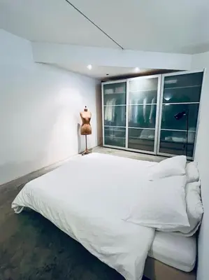a bedroom with a large white bed and a window at Loft Antwerp - Eilandje in Antwerp