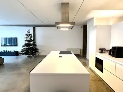 a kitchen with a white counter and a christmas tree at Loft Antwerp - Eilandje in Antwerp