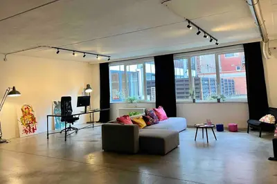 a living room with a couch and a table at Loft Antwerp - Eilandje in Antwerp
