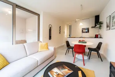 a living room with a white couch and a table at Beautiful 1BR apartment in Antwerp in Antwerp