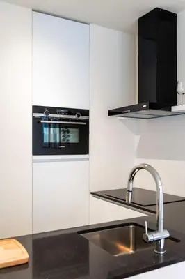 a kitchen with a sink and a stove at Beautiful 1BR apartment in Antwerp in Antwerp
