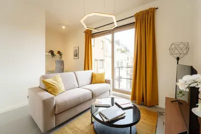 a living room with a couch and a table at Apartments in Antwerp South in Antwerp