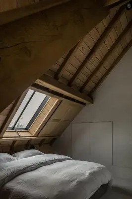 a bedroom with a bed and a large window at Etablo B&B in Bornem