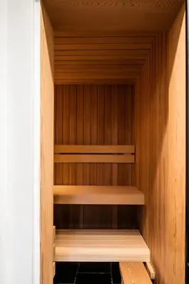 a sauna with wooden walls and wooden shelves at Etablo B&B in Bornem