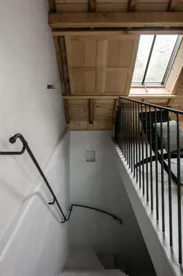 a staircase in a house with a wooden ceiling at Etablo B&B in Bornem