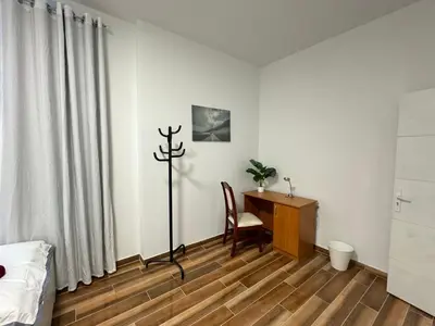 a bedroom with a desk and a table with a chair at Sweet Dream House in Brussels