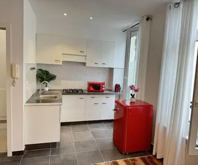 a kitchen with a red refrigerator and a sink at Sweet Dream House in Brussels