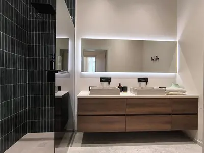 a bathroom with two sinks and a mirror at Stunning Riverview apartment in Antwerp