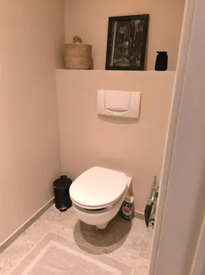 a bathroom with a white toilet in a room at Stunning Riverview apartment in Antwerp