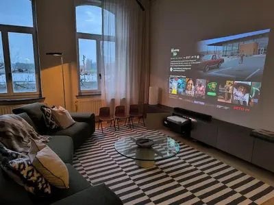 a living room with a couch and a flat screen tv at Stunning Riverview apartment in Antwerp