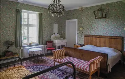a bedroom with a bed and a couch at Kasteel Ter Leyen in Assenede
