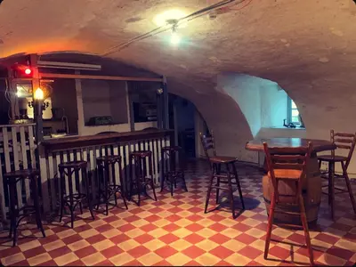 a bar with chairs and tables in a room at Kasteel Ter Leyen in Assenede