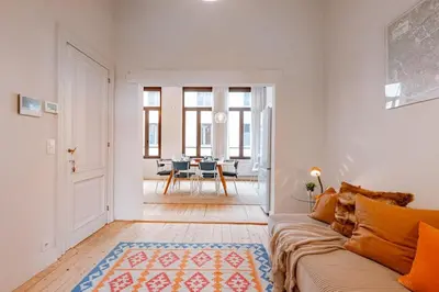 a living room with a couch and a table at Charming mansion in vibrant Antwerp in Antwerp