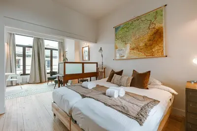 a bedroom with a large bed with a map on the wall at Charming mansion in vibrant Antwerp in Antwerp