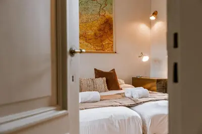 a bedroom with a bed with a map on the wall at Charming mansion in vibrant Antwerp in Antwerp