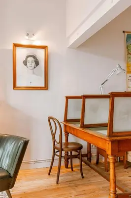 a desk and chair in a room with a picture on the wall at Charming mansion in vibrant Antwerp in Antwerp