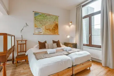 a bedroom with a large bed with a map on the wall at Charming mansion in vibrant Antwerp in Antwerp