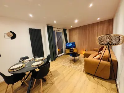 a living room with a table and a couch at Cozy Flat in Brussels
