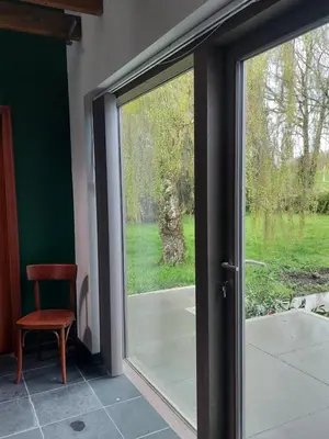 a sliding glass door with a view of a yard at Vakantiewoning Nieuwdonk in Berlare