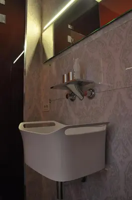 a bathroom with a white sink and a mirror at Schopenhauer in Ghent