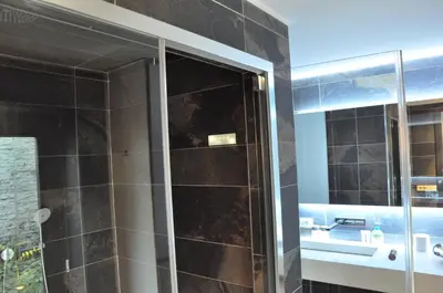 a bathroom with a shower with a glass door at Schopenhauer in Ghent