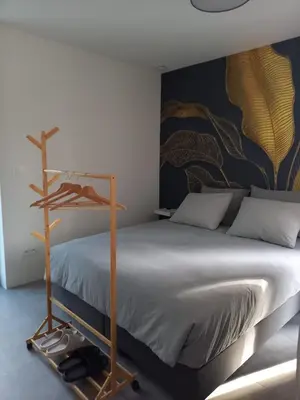 a bedroom with a bed and a wall with a painting at Starling in Oud-Turnhout