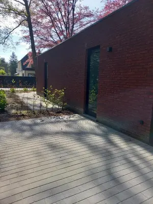 a brick building with a door and a patio at Starling in Oud-Turnhout