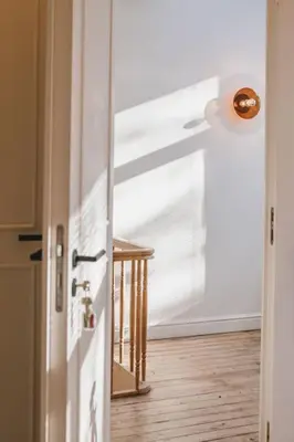 an open door to a room with a wooden floor at Your colourful Antwerp Oasis in Antwerp