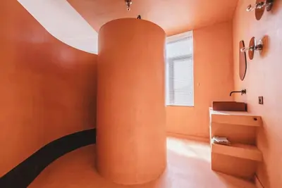 an orange room with a column in the middle of it at Your colourful Antwerp Oasis in Antwerp