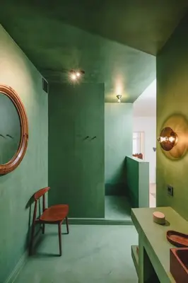 a room with a chair and a table and a mirror at Your colourful Antwerp Oasis in Antwerp