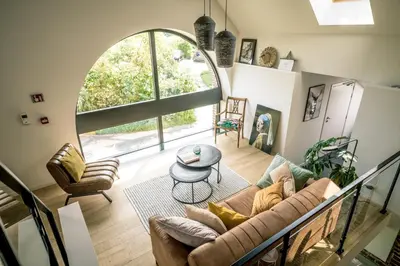 a living room with a couch and a table at Vakantiewoning De Woestijn - De Schuur in Roosdaal
