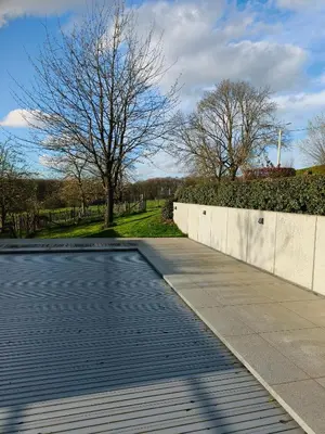 a swimming pool on the side of a sidewalk at Vakantiewoning De Woestijn - De Schuur in Roosdaal