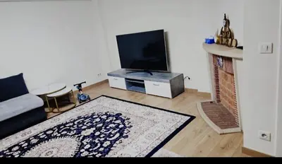 a living room with a couch and a tv at Luxurious 3 in Brussels
