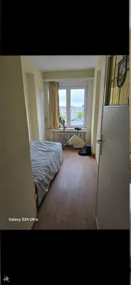 a bedroom with a bed and a large window at Luxurious 3 in Brussels