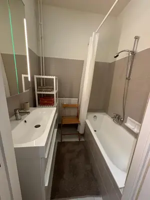 a bathroom with a tub and a sink and a bath tub at Studio Winston Churchill in Brussels