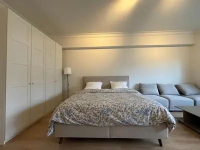 a bedroom with a bed and a couch at Studio Winston Churchill in Brussels