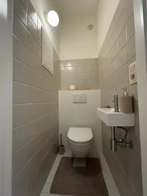 a bathroom with a toilet and a sink at Studio Winston Churchill in Brussels
