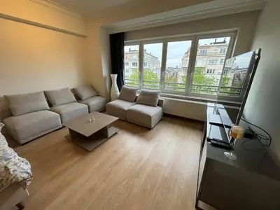 a living room with a couch and a table at Studio Winston Churchill in Brussels