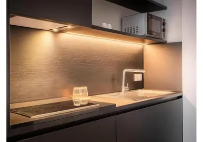 a kitchen with a sink and a counter top at Hotel Jamingo in Antwerp