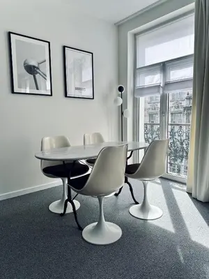 a dining room with a table and chairs and a window at Magnifique appartement au coeur du SABLON ! in Brussels