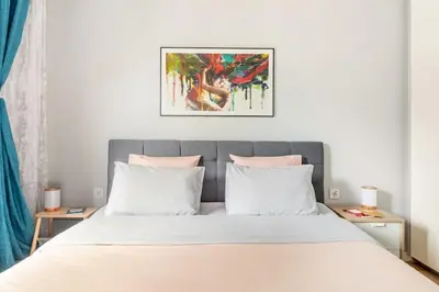 a bedroom with a large bed with two pillows at European heart 2-bedroom flat. in Brussels