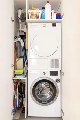 a washer and dryer in a utility room at European heart 2-bedroom flat. in Brussels