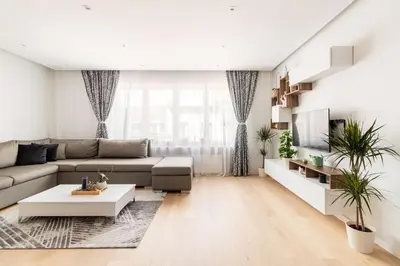 a living room with a couch and a table at European heart 2-bedroom flat. in Brussels