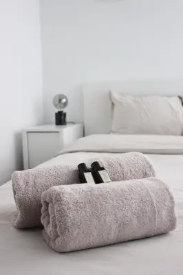 a pair of towels sitting on top of a bed at Sunny Apartment - Zuid Retreat 1BR Apartment near Scheldt River in Antwerp
