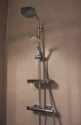 a shower with a shower head on top at Sunny Apartment - Zuid Retreat 1BR Apartment near Scheldt River in Antwerp