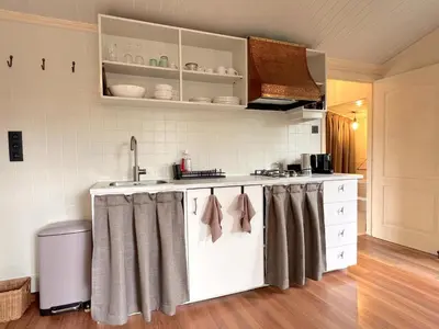a kitchen with a sink and a counter top at Charlies Chalet in Geel