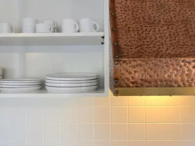 a cupboard with plates and cups on it at Charlies Chalet in Geel