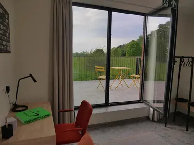 a living room with a view of a patio at Trionfo in Gaasbeek
